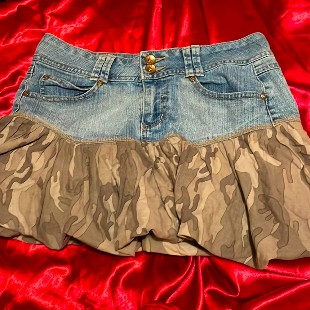 It’s a Jean skirt that has a camo poofy flare at bottem